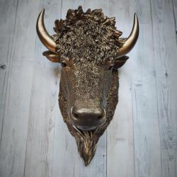 Faux taxidermy bison head, painted antique gold with black accenting.
