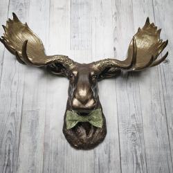 faux taxidermy moose head wall mount, painted dark copper with antique gold accents and antique gold antlers. A green bow tie accents the neck.