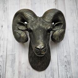 Black faux taxidermy ram head with gold accents.