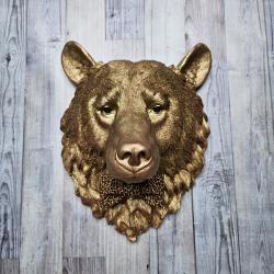 faux taxidermy bear head wall mount, painted gold with rose gold accents. a leopard bow tie accents the neck of the bear.