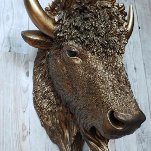Faux taxidermy bison head, painted antique gold with black accenting.