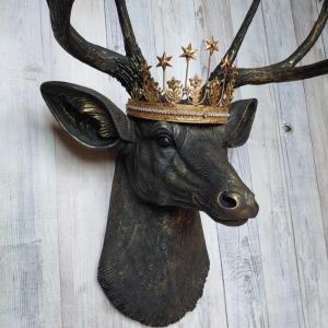 Faux taxidermy deer head wall mount painted black with gold accents. A gold Santos star crown accents the top of the deers head.