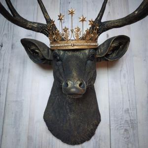 Faux taxidermy deer head wall mount painted black with gold accents. A gold Santos star crown accents the top of the deers head.
