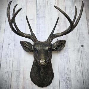 faux taxidermy deer head wall mount, painted black with dark copper accents.