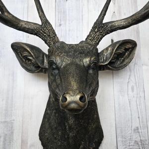 faux taxidermy deer head wall mount, painted black with dark copper accents.
