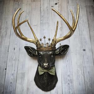 Faux taxidermy deer head wall mount with star Santos crown and a bow tie.