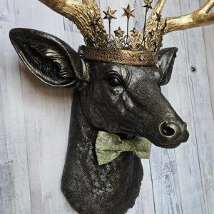 Faux taxidermy deer head wall mount with star Santos crown and a bow tie.
