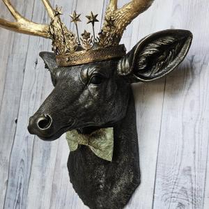 Faux taxidermy deer head wall mount with star Santos crown and a bow tie.