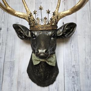 Faux taxidermy deer head wall mount with star Santos crown and a bow tie.
