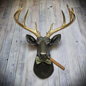 faux taxidermy deer head with cigar and bow tie.