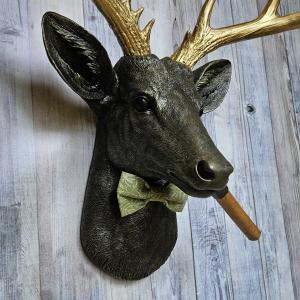 faux taxidermy deer head with cigar and bow tie.