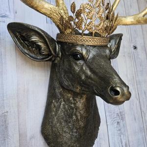 Faux taxidermy deer head wall mount, painted rubbed bronze with gold antlers and gold accents. A metal leaf work gold crown rests atop the deers head.