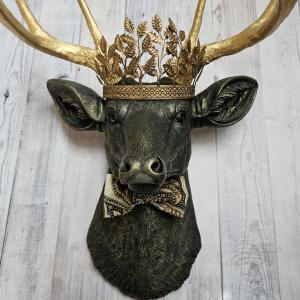 Faux taxidermy deer head with gold metal leaf crown and bow tie.