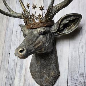 faux taxidermy deer head that's been painted chestnut brown with gold and antique white accents, the antlers are painted in the same color combination. A vintage bronze Santos metal crown with rhinestones accents the top of the deers head.