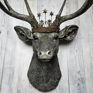 faux taxidermy deer head that's been painted chestnut brown with gold and antique white accents, the antlers are painted in the same color combination. A vintage bronze Santos metal crown with rhinestones accents the top of the deers head.
