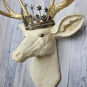 Faux taxidermy deer head wall mount, painted antique white with gold accents and gold antlers. A vintage rhinestone encrusted Santos star crown rests atop the deers head.