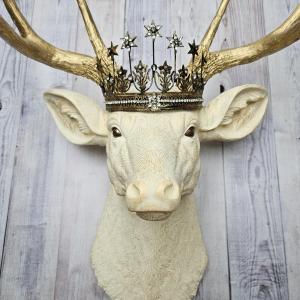 Faux taxidermy deer head wall mount, painted antique white with gold accents and gold antlers. A vintage rhinestone encrusted Santos star crown rests atop the deers head.
