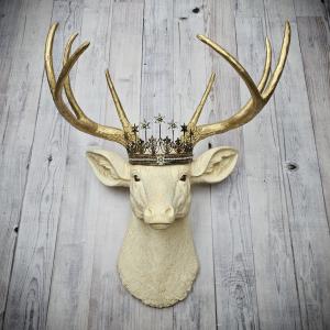 Faux taxidermy deer head wall mount, painted antique white with gold accents and gold antlers. A vintage rhinestone encrusted Santos star crown rests atop the deers head.