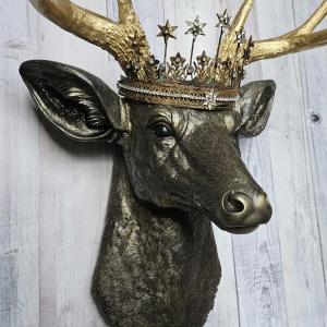 Faux taxidermy deer head wall mount, painted rubbed bronze with gold accents and gold antlers. A vintage rhinestone encrusted Santos star crown rests atop the deers head.