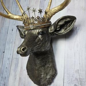 Faux taxidermy deer head wall mount, painted rubbed bronze with gold accents and gold antlers. A vintage rhinestone encrusted Santos star crown rests atop the deers head.