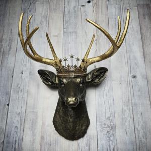 Faux taxidermy deer head wall mount, painted rubbed bronze with gold accents and gold antlers. A vintage rhinestone encrusted Santos star crown rests atop the deers head.