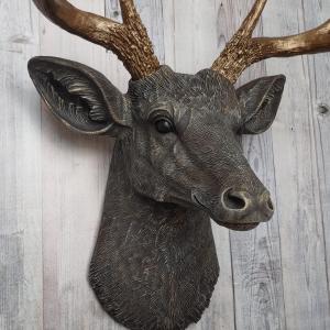 Faux taxidermy deer head painted chestnut brown and accented with antique white and antique gold, in order to bring out the beautiful details in the cast. The antlers have been painted antique gold and the eyes have been painted black.