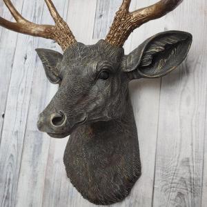 Faux taxidermy deer head painted chestnut brown and accented with antique white and antique gold, in order to bring out the beautiful details in the cast. The antlers have been painted antique gold and the eyes have been painted black.