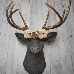 Faux taxidermy deer head, painted chestnut brown with antique white and gold accenting. The antlers are antique gold and a cream floral crown sits atop the deer head.