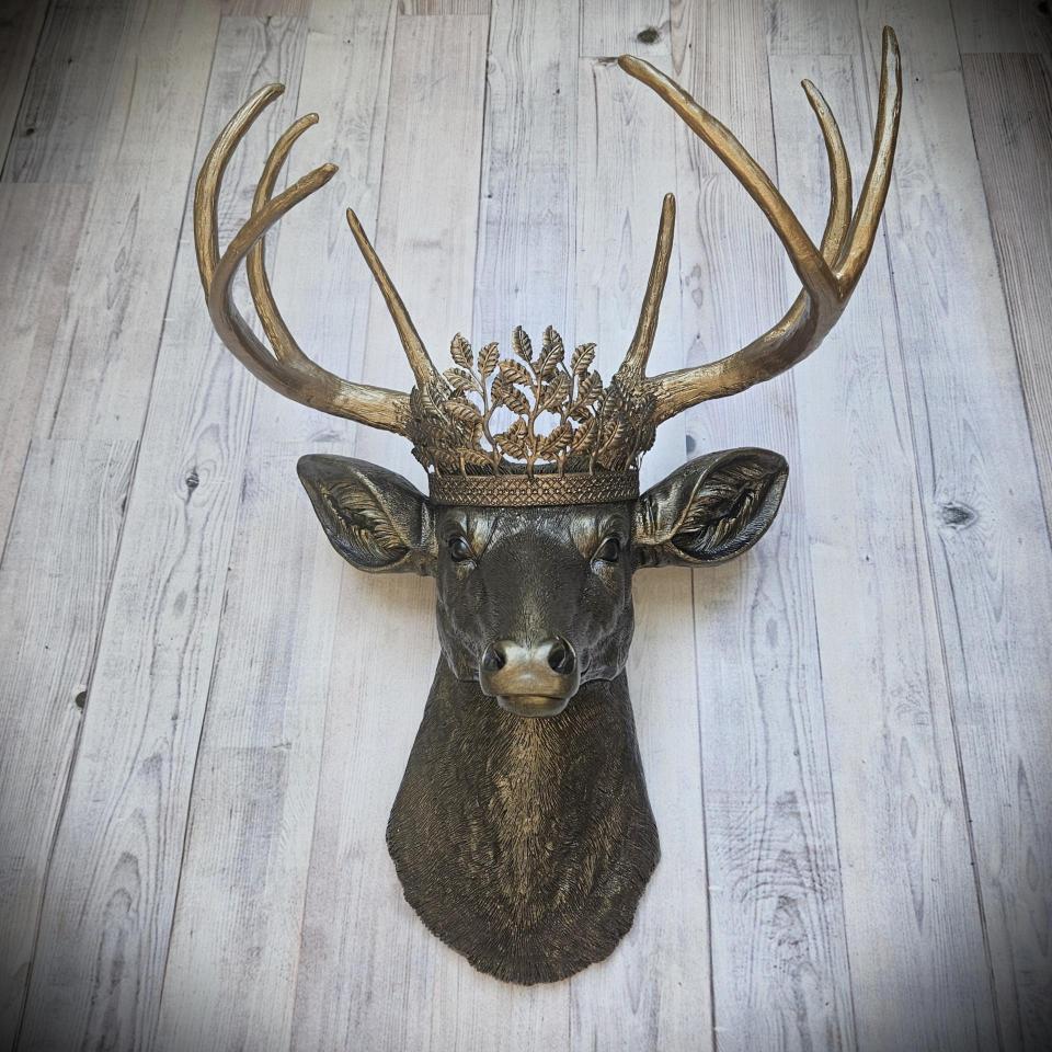 Faux taxidermy deer head wall mount. Painted rubbed bronze with antique gold accents. The antlers are antique gold and an antique gold metal leaf crown rests atop the deer head.
