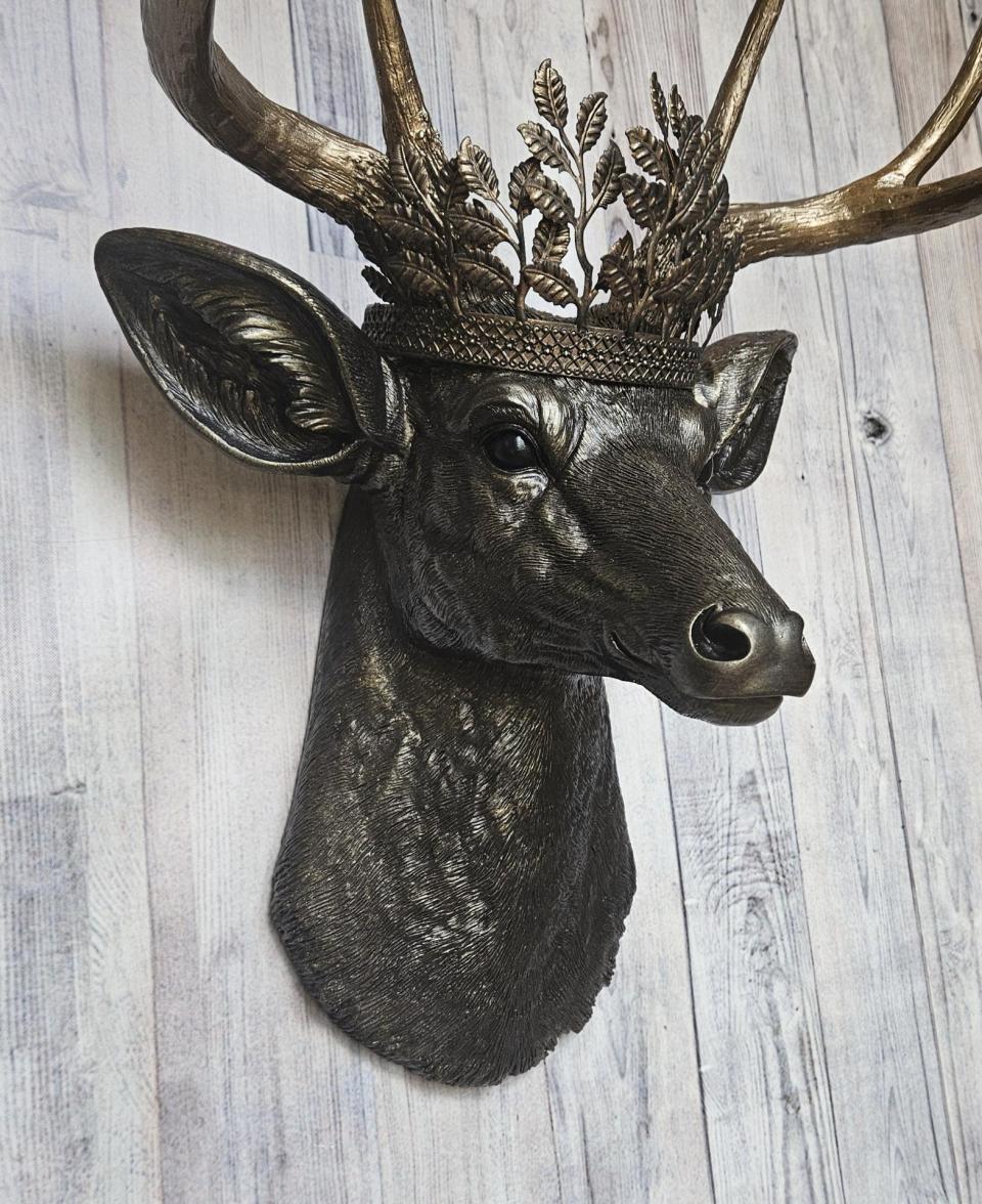 Faux taxidermy deer head wall mount. Painted rubbed bronze with antique gold accents. The antlers are antique gold and an antique gold metal leaf crown rests atop the deer head.