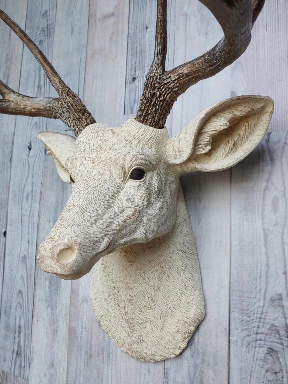Faux taxidermy deer head wall mount. Head is painted antique white with antique gold accents, antlers are antique gold with antique white accents.