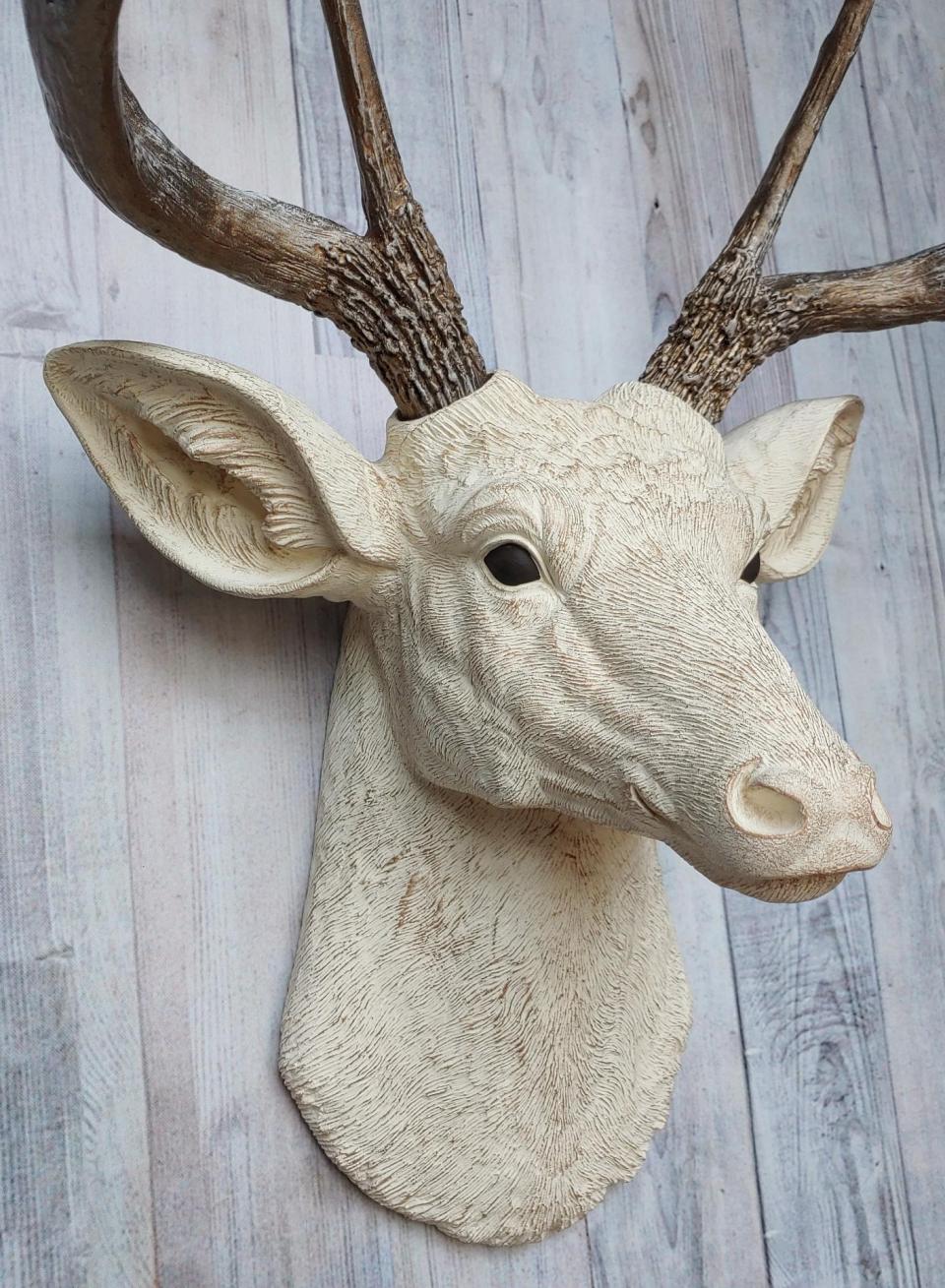 Faux taxidermy deer head wall mount. Head is painted antique white with antique gold accents, antlers are antique gold with antique white accents.