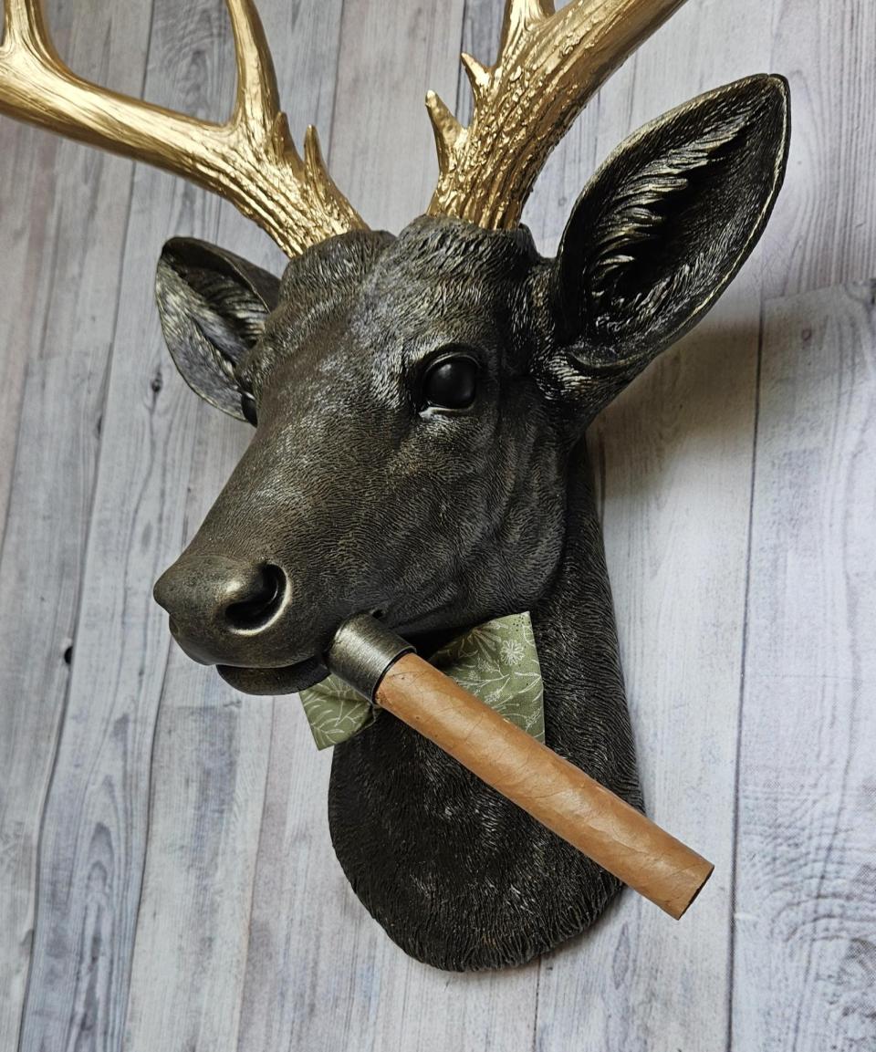 faux taxidermy deer head with cigar and bow tie.