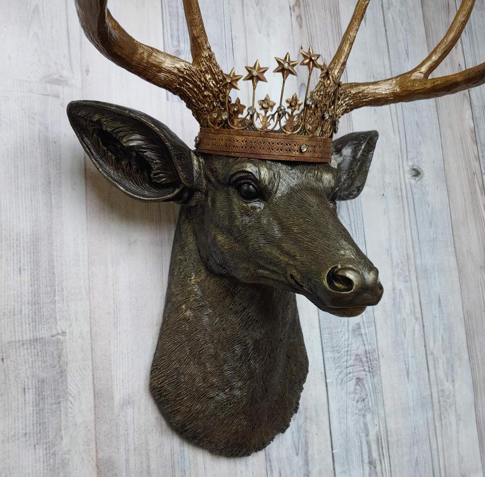 Faux taxidermy stag head, faux taxidermy deer head that's been painted rubbed bronze with antique gold accents. The antlers have been painted antique gold and a vintage inspired Santos crown adorns the deers head.