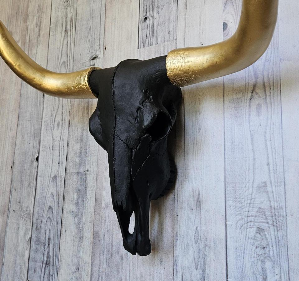 faux taxidermy steer skull, painted black with gold horns