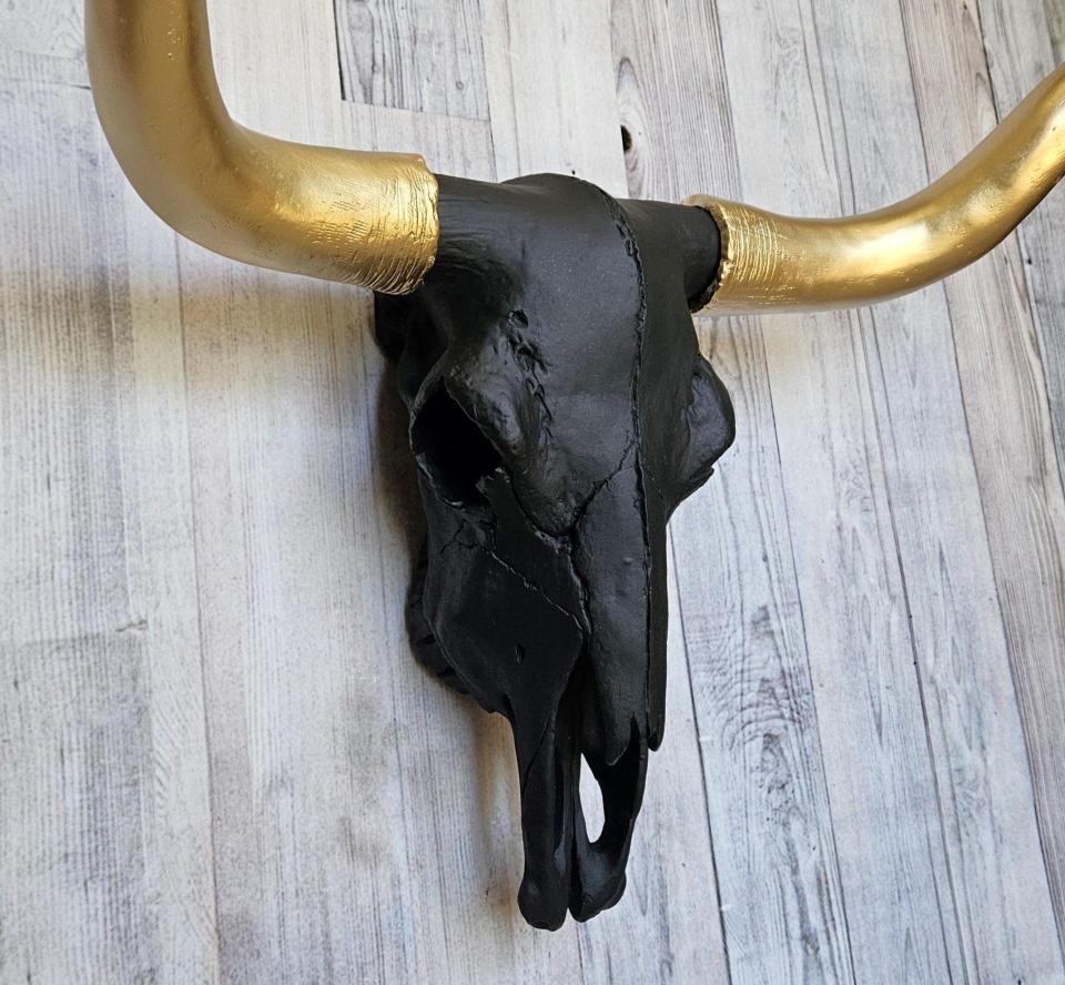 faux taxidermy steer skull, painted black with gold horns