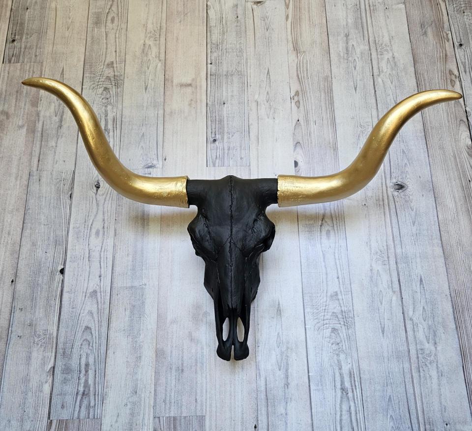faux taxidermy steer skull, painted black with gold horns