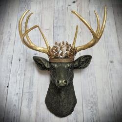 faux taxidermy deer head wall mount in black with gold accenting and gold antler. A gold metal work crown rests atop the deers head.