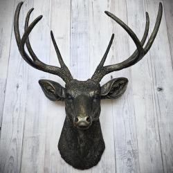 faux taxidermy deer head wall mount, painted black with dark copper accents.