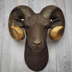 Faux taxidermy ram head, painted brown with gold tipped horns that are graduated in color.