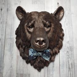Faux taxidermy bear head painted dark copper with black accenting with mulit dark blue and white fabric bow tie.