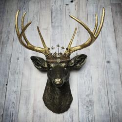 Faux taxidermy deer head wall mount, painted rubbed bronze with gold accents and gold antlers. A vintage rhinestone encrusted Santos star crown rests atop the deers head.