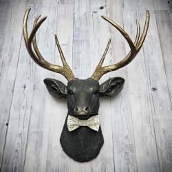 Faux taxidermy deer head, painted slate grey with antique gold accents.  A rovable bow tie accents the neck of the deerem.