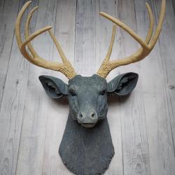 Faux taxidermy deer head that's been painted slate grey with desert sand color accents. The antlers have been painted desert sand.