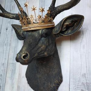 Faux taxidermy deer head wall mount painted black with gold accents. A gold Santos star crown accents the top of the deers head.