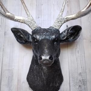 Faux taxidermy deer head, painted black with silver accenting on the deers head, the antler have been painted metallic silver.