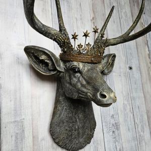 faux taxidermy deer head that's been painted chestnut brown with gold and antique white accents, the antlers are painted in the same color combination. A vintage bronze Santos metal crown with rhinestones accents the top of the deers head.