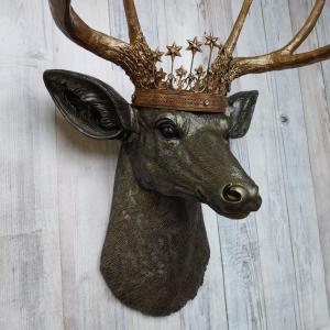Faux taxidermy stag head, faux taxidermy deer head that's been painted rubbed bronze with antique gold accents. The antlers have been painted antique gold and a vintage inspired Santos crown adorns the deers head.