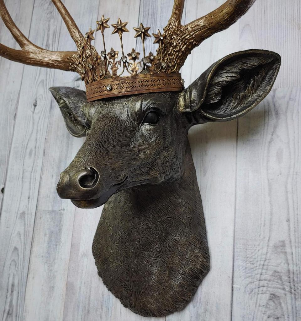 Faux taxidermy stag head, faux taxidermy deer head that's been painted rubbed bronze with antique gold accents. The antlers have been painted antique gold and a vintage inspired Santos crown adorns the deers head.