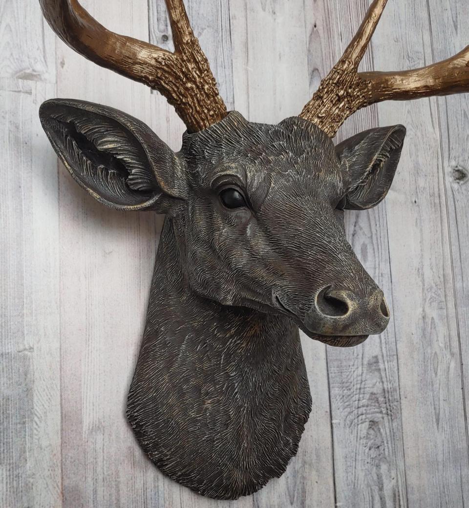 Faux taxidermy deer head painted chestnut brown and accented with antique white and antique gold, in order to bring out the beautiful details in the cast. The antlers have been painted antique gold and the eyes have been painted black.